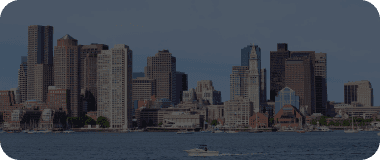 Panoramic view of downtown Boston's historic waterfront and skyscrapers under a clear sky