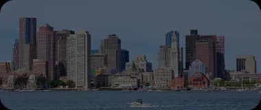 Panoramic view of downtown Boston's historic waterfront and skyscrapers under a clear sky
