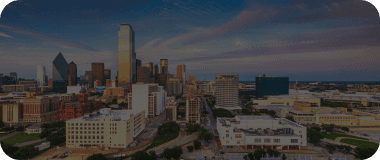 Cityscape of Dallas at golden hour featuring iconic buildings and a sprawling downtown