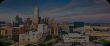 Cityscape of Dallas at golden hour featuring iconic buildings and a sprawling downtown