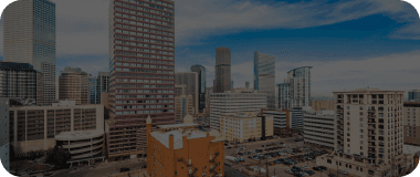 Denver skyline with mountain views and modern architecture.