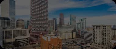 Denver skyline with mountain views and modern architecture.