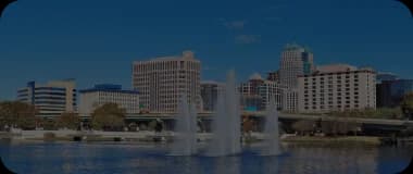 Fountains in front of a waterfront cityscape in Fort Myers.