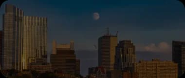 Evening skyline of Fort Worth with warm lighting and high-rise buildings