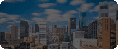 Modern skyline of Houston with a backdrop of bright clouds