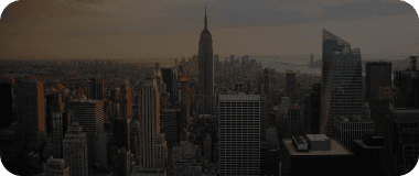 Iconic Manhattan skyline with Empire State Building at dusk.