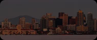 San Diego downtown skyline with mountains in the background at twilight