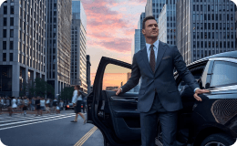 Executive stepping out of a premium SUV on a city street at sunset, highlighting diverse vehicle availability.