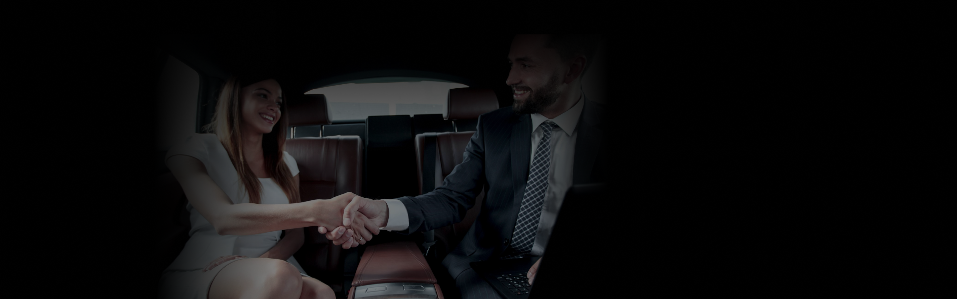 Client & Partner Travel experience shown as two professionals shake hands inside a luxury car's backseat.